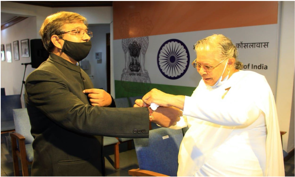 B. K. Sister Janaki tying a Rakhi on the wrist of H. E. the Consulate General Mr. Prakash Chand.